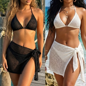 Detail of crochet beach set featuring lace-up halter top and hollow-out mesh sarong skirt