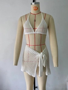 Detailed close-up of white crochet knit beach set showing hollow mesh texture and ties