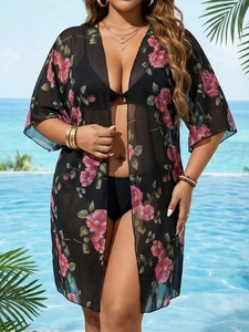 Detail of floral mesh beach cover-up with pink rose prints and batwing sleeves