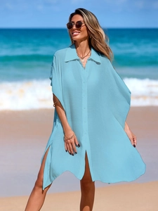 Loose light blue beach cover-up shirt with polo collar and side slits for a vacation look