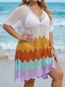 Detailed close-up of multi-color crochet wave patterns and hollow knit beach dress texture