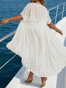 White sheer polka dot chiffon beach cover up with flared sleeves for women on a boat