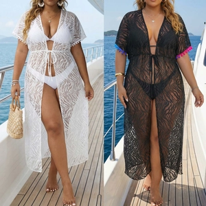 Detail of plus size lace beach cover up with animal texture and colorful tassels