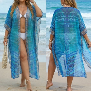 Detail of bohemian leopard print beach cover-up with sheer blue geometric pattern