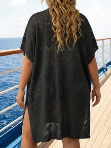 Détail de la tunique de plage noire au crochet avec motifs de cœurs et fentes