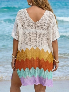 Close-up of crochet beach cover-up featuring colorful wave patterns and a sexy V-neck back