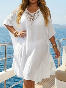Close-up of white crochet V-neck beach cover-up dress with cold shoulder design