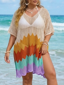 Detail of crochet beach cover-up featuring rainbow wave patterns and side slit design