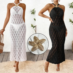 Detail of a golden starfish metal ornament on a white crochet knit beach cover-up dress
