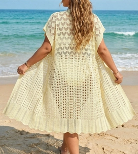 Back view of a beige crochet beach cover-up featuring geometric hollow patterns
