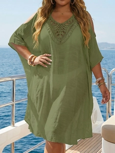 Detail of green crochet knit neckline and sheer fabric on a plus size beach cover-up dress