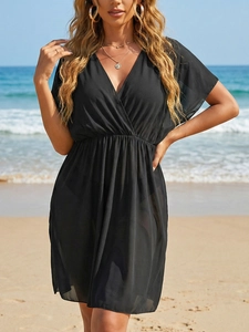 Close-up of black mesh beach cover-up with elastic waist and ruffled sleeve details