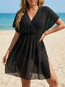 Close-up of black sheer beach cover-up featuring a deep V-neck and high waist details