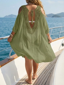 Detail of crochet lace V-back design with fringe ties on olive green beach cover-up dress