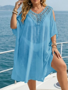 Detail of light blue beach cover-up featuring crochet V-neckline and cold-shoulder cutouts