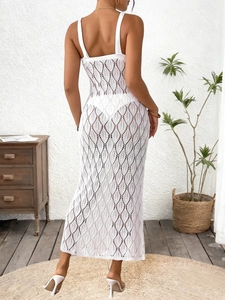 Detail view of white crochet cutout maxi dress with backless design and hollow knit pattern