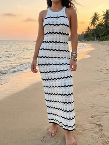 Détail d'une robe en maille crochetée blanche à rayures noires au coucher du soleil