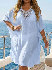 Detail of light blue crochet v-neckline and cold shoulder design on beach dress