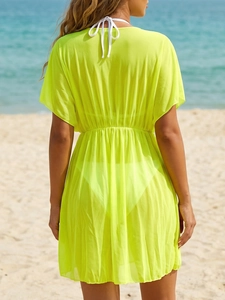 Women's beach cover-up in neon green with deep V-back, drawstring, and sheer mesh fabric