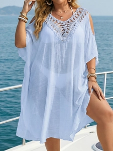 Detailed view of light blue crochet V-neck beach cover up on a luxury yacht