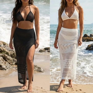 Detail of crochet knit bikini top and side slit maxi skirt set in black and white colors