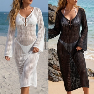 Detail of crochet beach cover-up with deep V-neck, bell sleeves and mesh knit texture