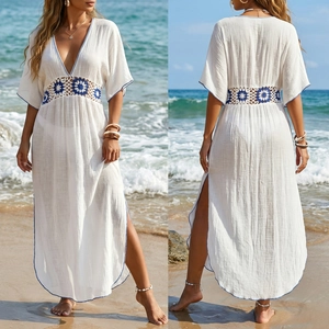 Detail of waist crochet patchwork and high side slits on white beach maxi dress