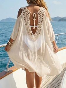 Bohemian crochet backless beach cover-up with fringe details on a yacht deck