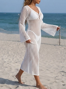 Detail of white crochet mesh beach cover-up with V-neckline and flare sleeves