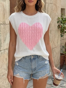 Detail of cable knit heart pattern on white sleeveless sweater with outdoor casual style