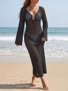 Close-up of golden starfish detail on black crochet mesh V-neck long beach cover-up dress