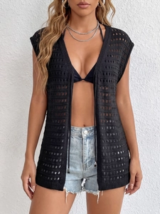 Detail of black crochet beach cover-up featuring geometric hollow out knit and drawstrings
