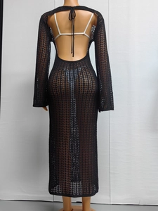 Detail of black crochet maxi dress with backless lace-up design and mesh knit texture