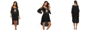 Detail of black bohemian beach cover-up with orange floral embroidery and flared sleeves