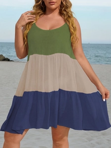 Detailed view of color-block tiered dress with green, beige and navy panels