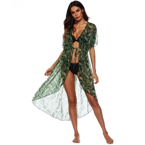 Detail view of a green tropical leaf print beach cover-up in lightweight chiffon fabric