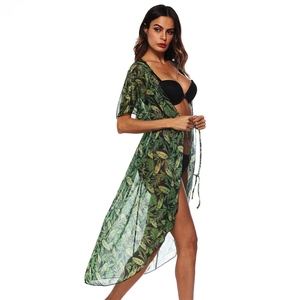 Detail of sheer green tropical palm leaf print beach cover-up with adjustable tie waist