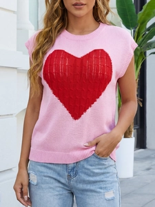 Close-up of pink knit top featuring a large red heart and high-quality woven texture