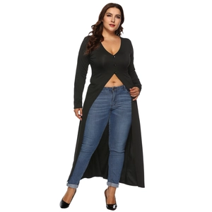 Detail view of a black V-neck long sleeve button-up tunic with irregular split hemline