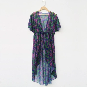 Detail of tropical print chiffon beach cover-up with drawstring waist and leaf patterns