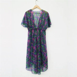 Detail of sheer tropical print beach cover-up featuring purple chiffon and leaf patterns