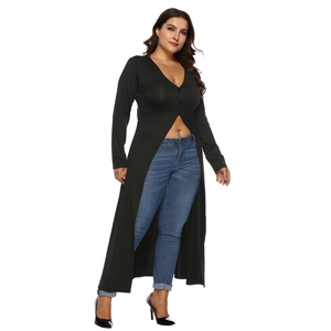 Detail view of long sleeve V-neck black top with buttons and slit hem on fashion model