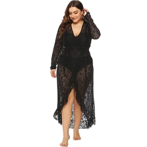 Detailed view of sheer floral lace fabric and ruffled hem on long black beach cover-up