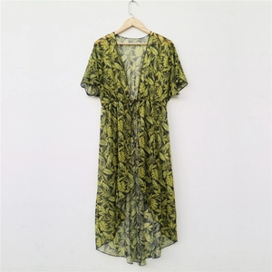 Detail view of semi-transparent tropical palm leaf print cardigan with drawstring waist