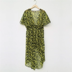 Detailed close-up of tropical leaf print on green sheer chiffon beach cover-up cardigan