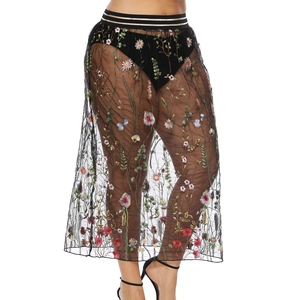 Détail de la broderie florale sur jupe en tulle noir avec taille élastique rayée