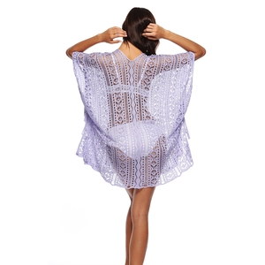 Detail of light purple crochet lace beach cover-up with intricate hollow-out floral patterns
