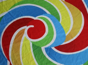 Macro detail of colorful spiral pizza pattern on lightweight polyester beach shawl fabric