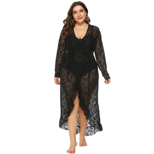 Detail of delicate black lace pattern and waist tie on long sleeve beach cover-up