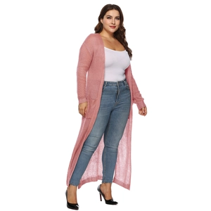 Dettaglio della maglia di un cardigan lungo rosa aperto con tasche laterali e polsini a coste